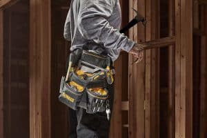 Neue Gürteltasche von DeWalt in schwarz-gelb, getragen von einem Mann auf auf einer Baustelle.